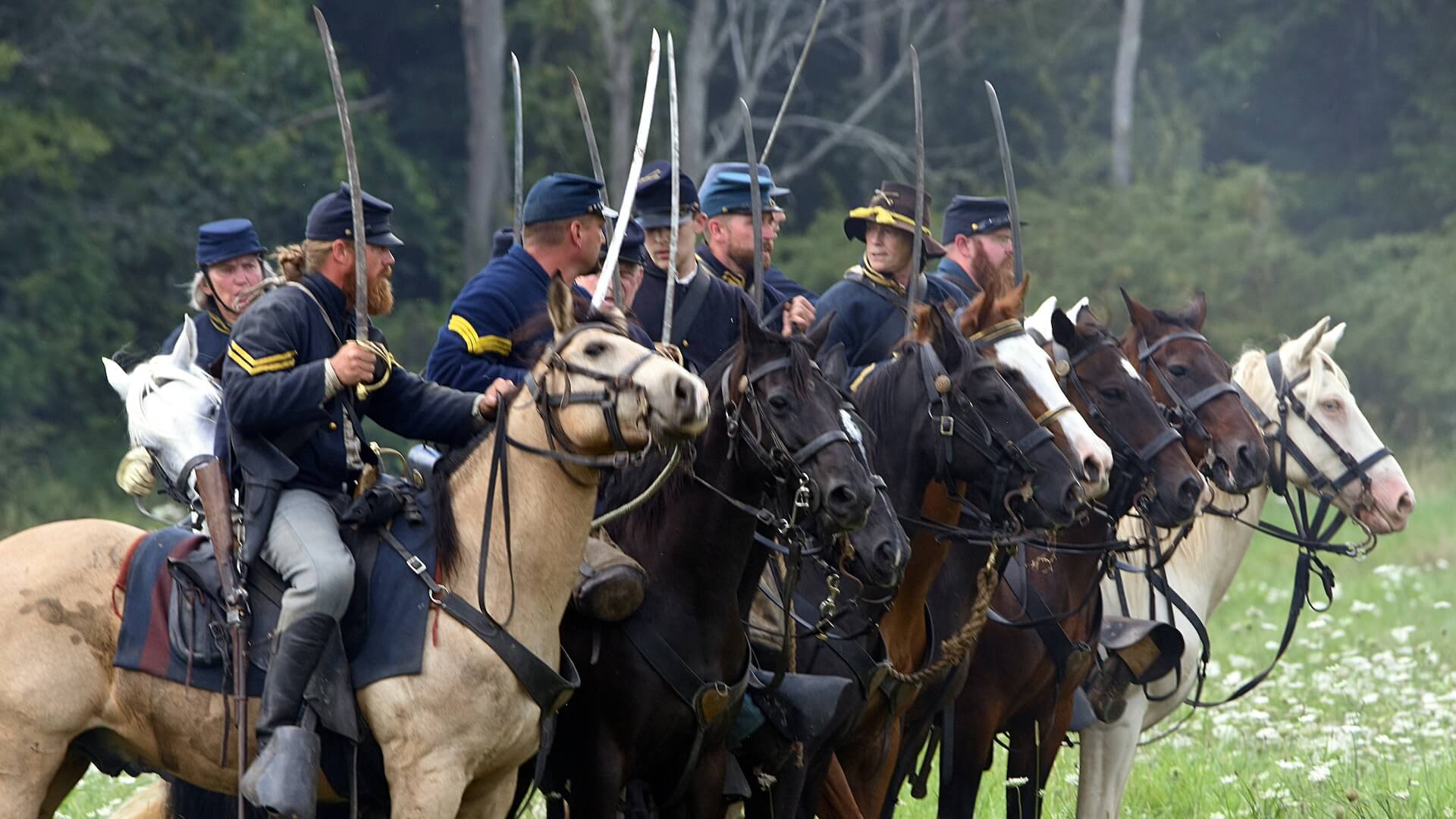 men riding horse on green grass field during daytime