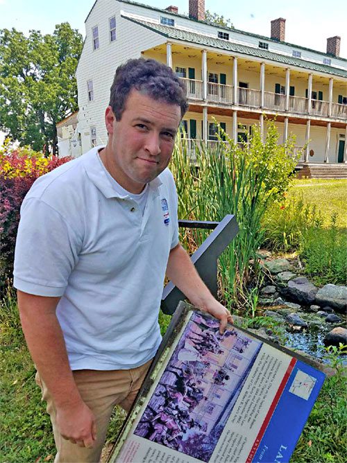 man standing in front of civil war trails plaque