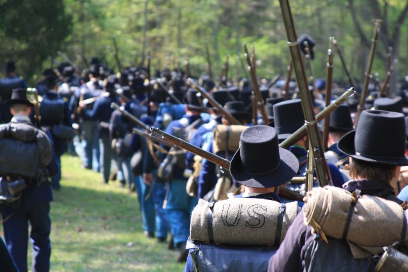 men riding horse on green grass field during daytime
