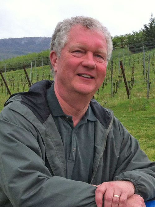 man with gray shirt near a field