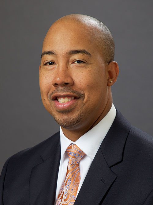 headshot of man with tie and jacket